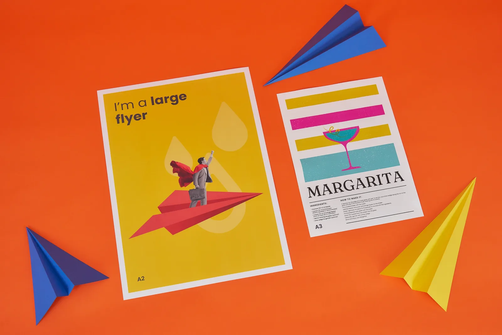 a2 yellow flyer with businessman flying on a paper airplane with text 'i'm a large flyer' a3 flyer with text 'margarita' on a bright orange background with yellow and blue paper airplanes