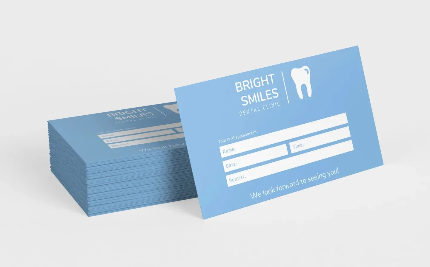 Business card featuring a blue background with white text, designed for dentist appointment reminders