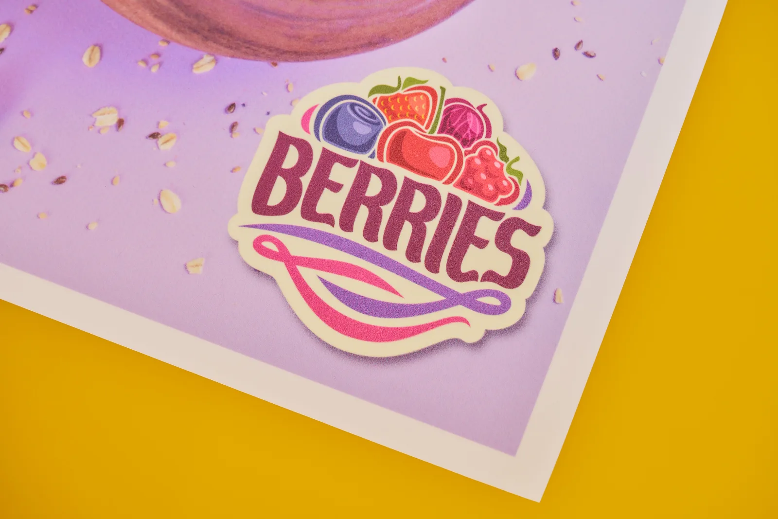 close up of a backlit bus shelter poster with the text 'berries' on a bright yellow background