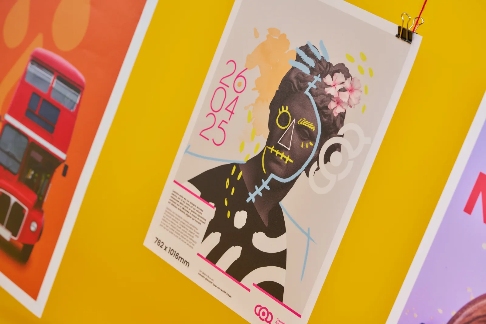 close up of a backlit 762 x 1016mm bus stop poster with abstract artwork of a concrete statue with copy '26 04 25' on bright yellow background