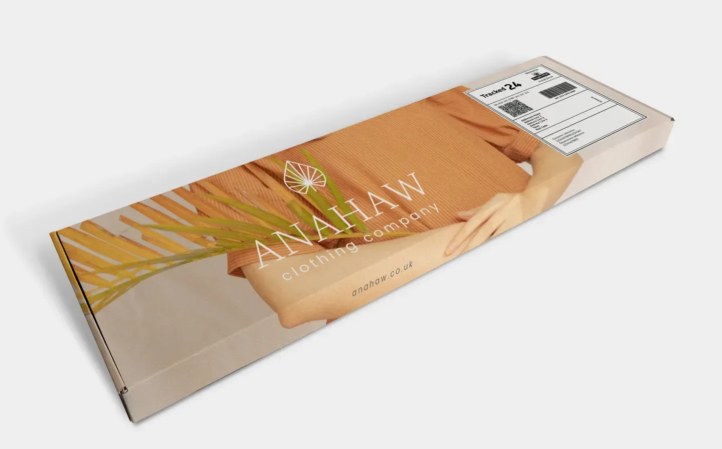 A large postal box featuring a clothing company's branding in a beige design on a blank background