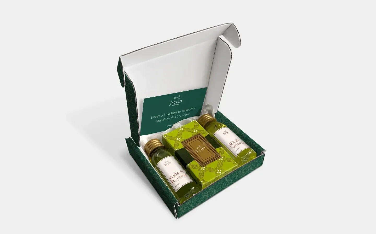 An open postal box displaying a green colour and two bottles of shampoo alongside a thank you card