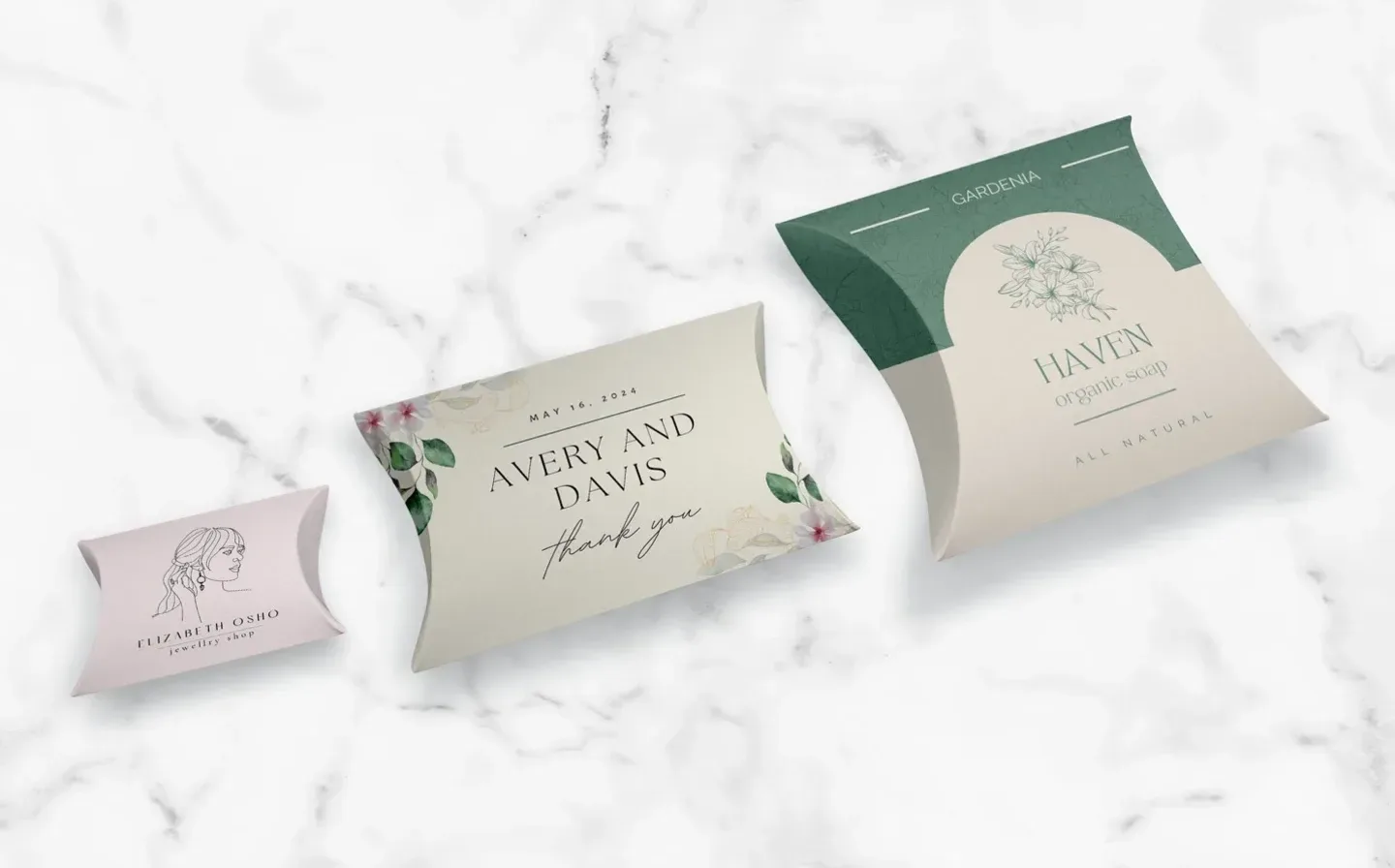 Three distinct pillow boxes displayed on a marble surface featuring elegant designs
