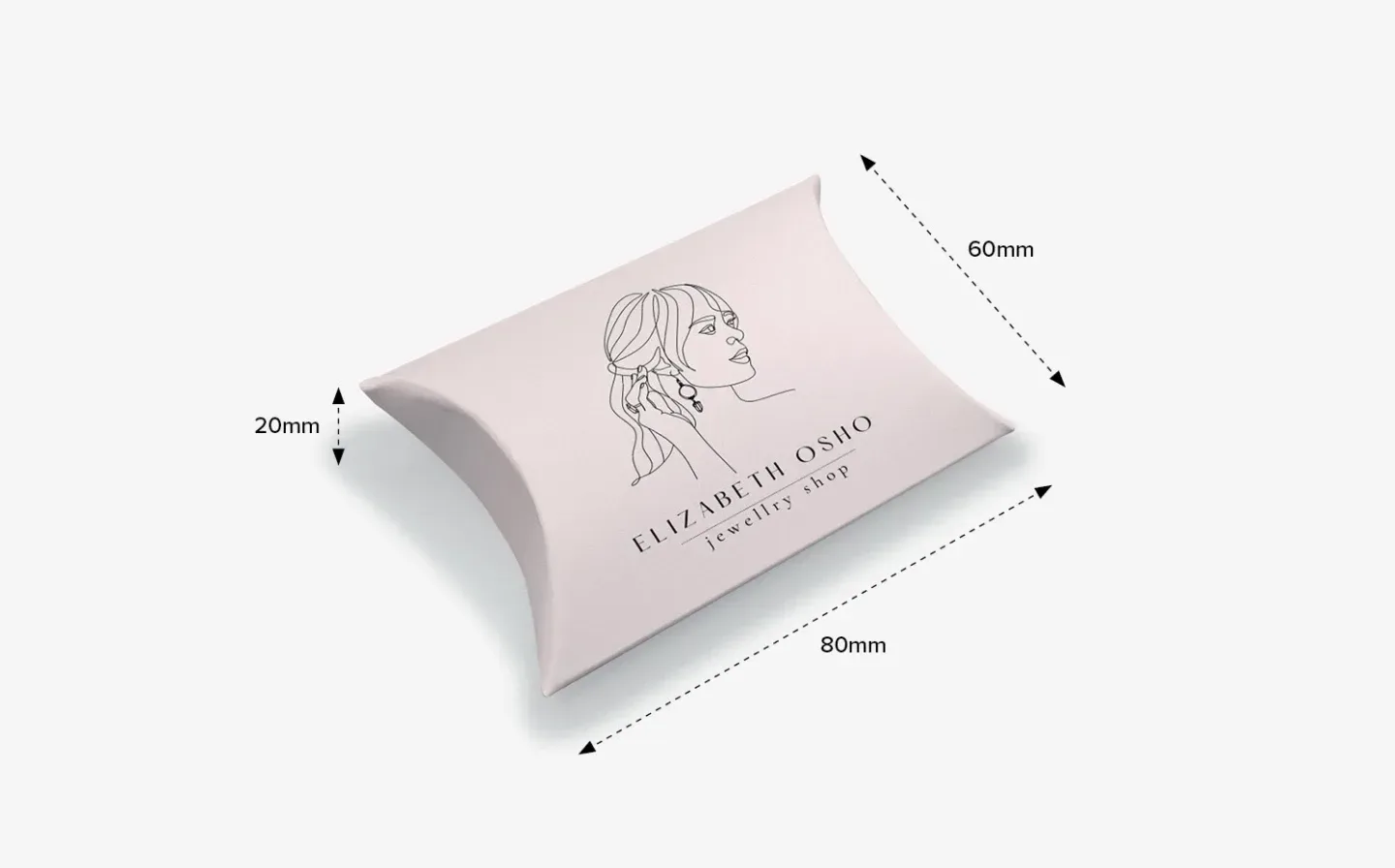 A small-sized pillow box with a woman's face, advertising a jewellery shop, along with dimensions
