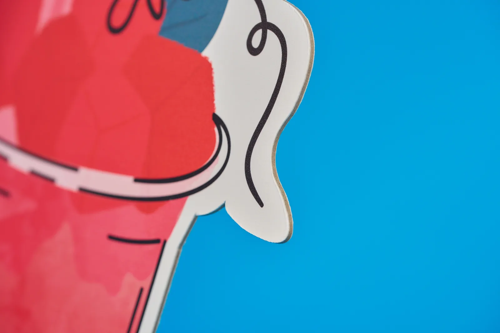 detail of a cut to shape display board on bright blue background
