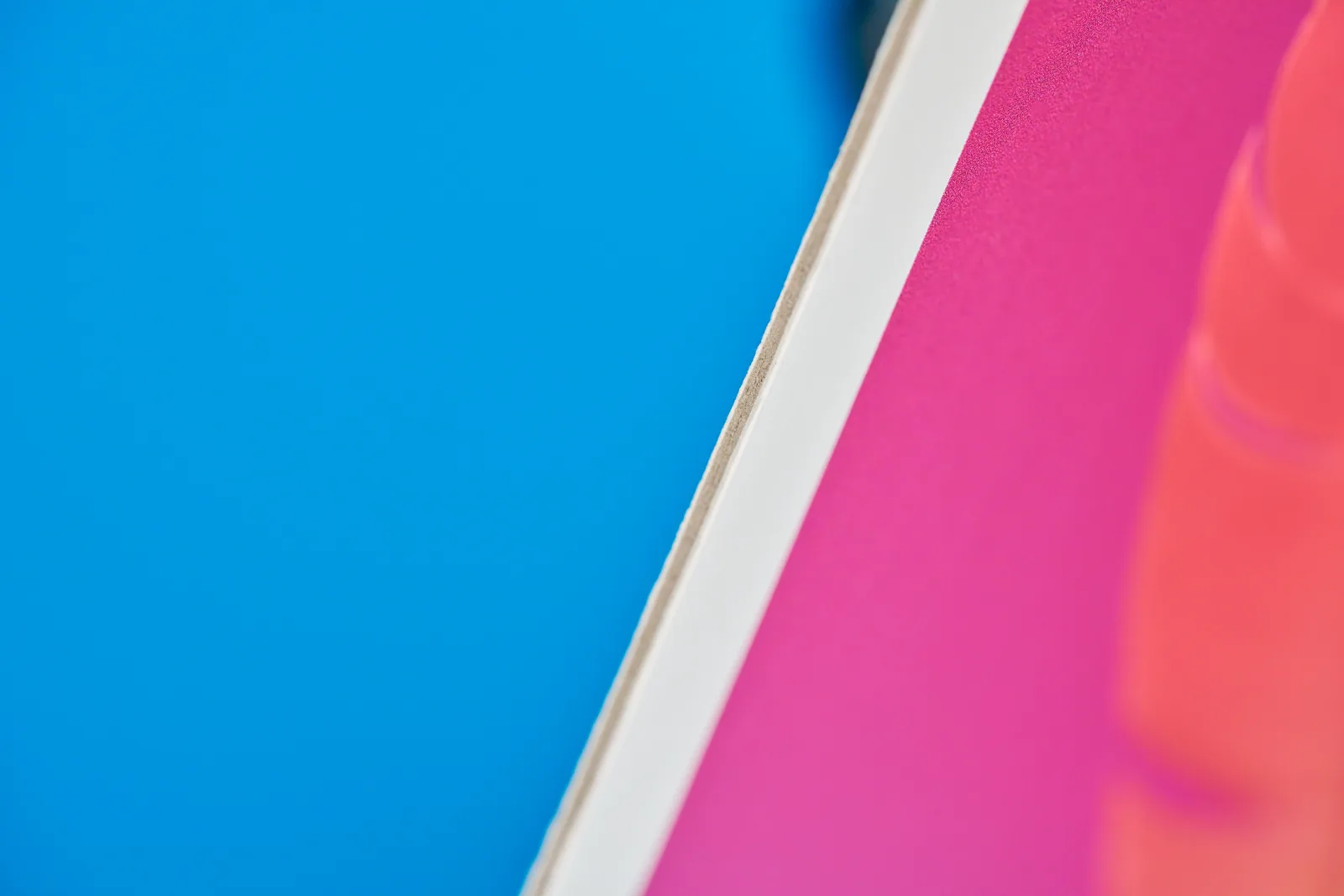 close up of a printed display board showing the thickness on a bright blue background