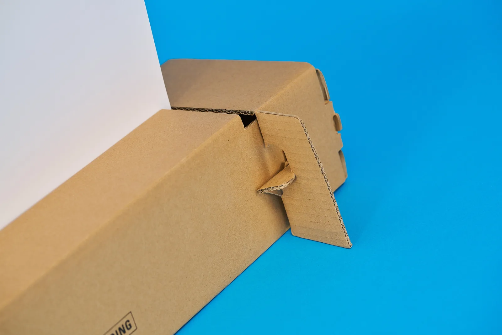 folded out cardboard base support of a eco roller banner ona. bright blue background