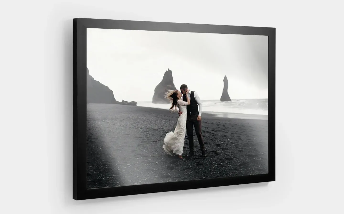 A framed photo depicting a couple on the beach, showcasing the quality of the frame