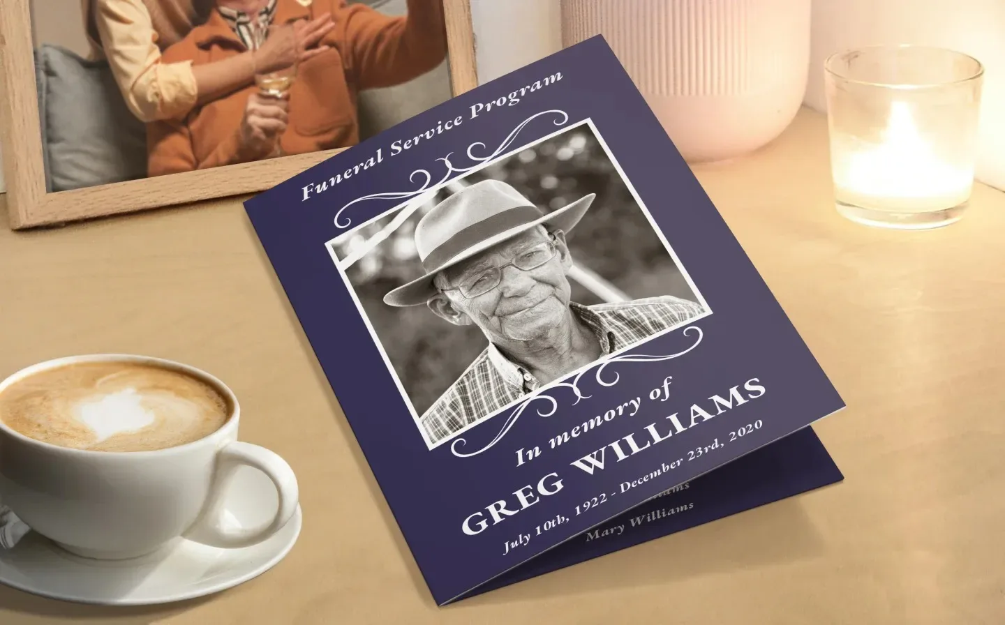 A desk with a coffee cup and a blue memorial card tribute for a fallen relative