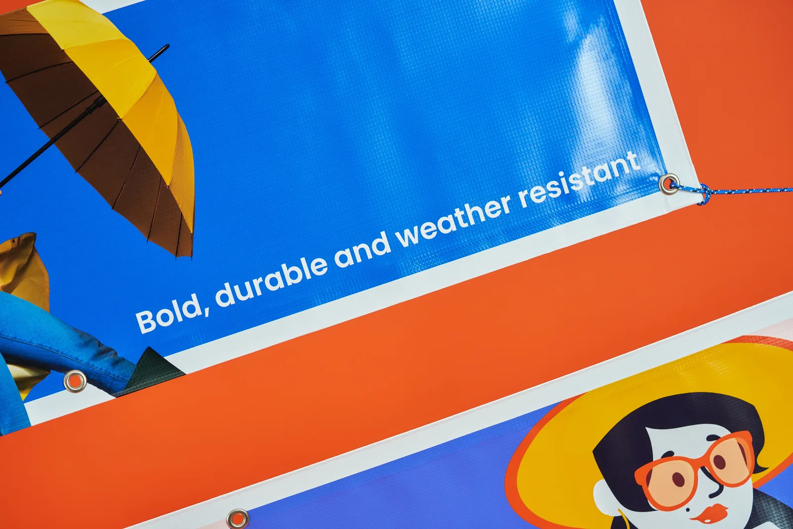 2 blue printed outdoor pvc banner with eyelets, blue rope, umbrella, illustration of woman in sunglasses and hat with the text 'bold, durable and weather resistant' on a bright orange backgr