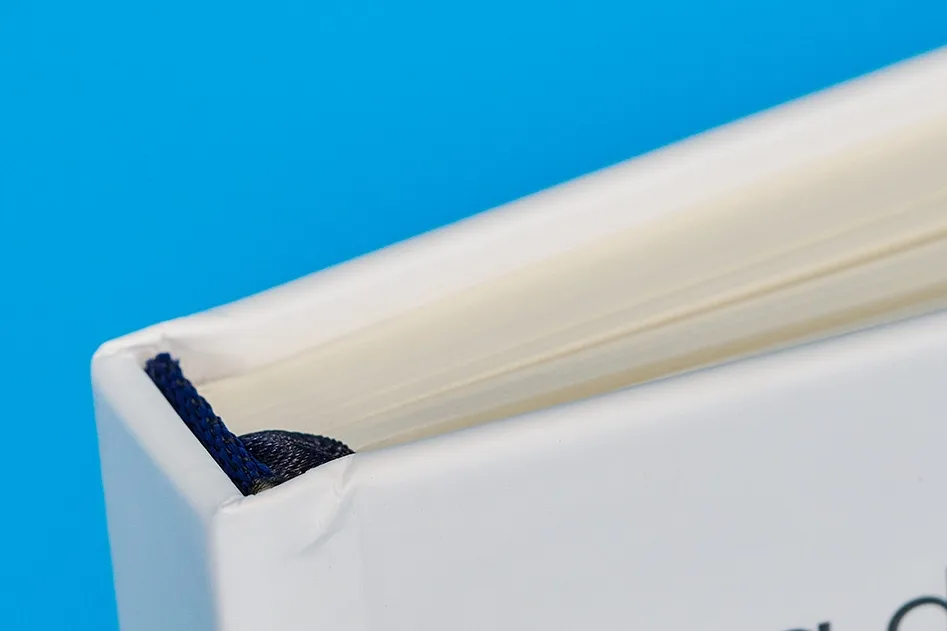 detail of the spine of a personalised notebook on bright blue background