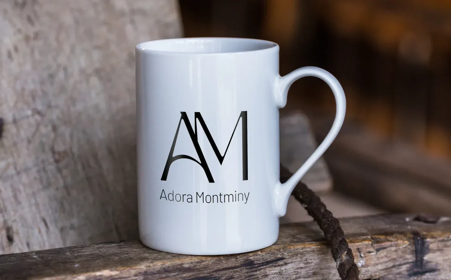 A porcelain mug displaying a name in a stylish font, placed on rustic wooden planks