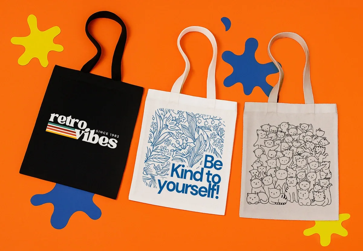Three tote bags on an orange background, one black with "retro vibes", one white with blue text and one with race day logo