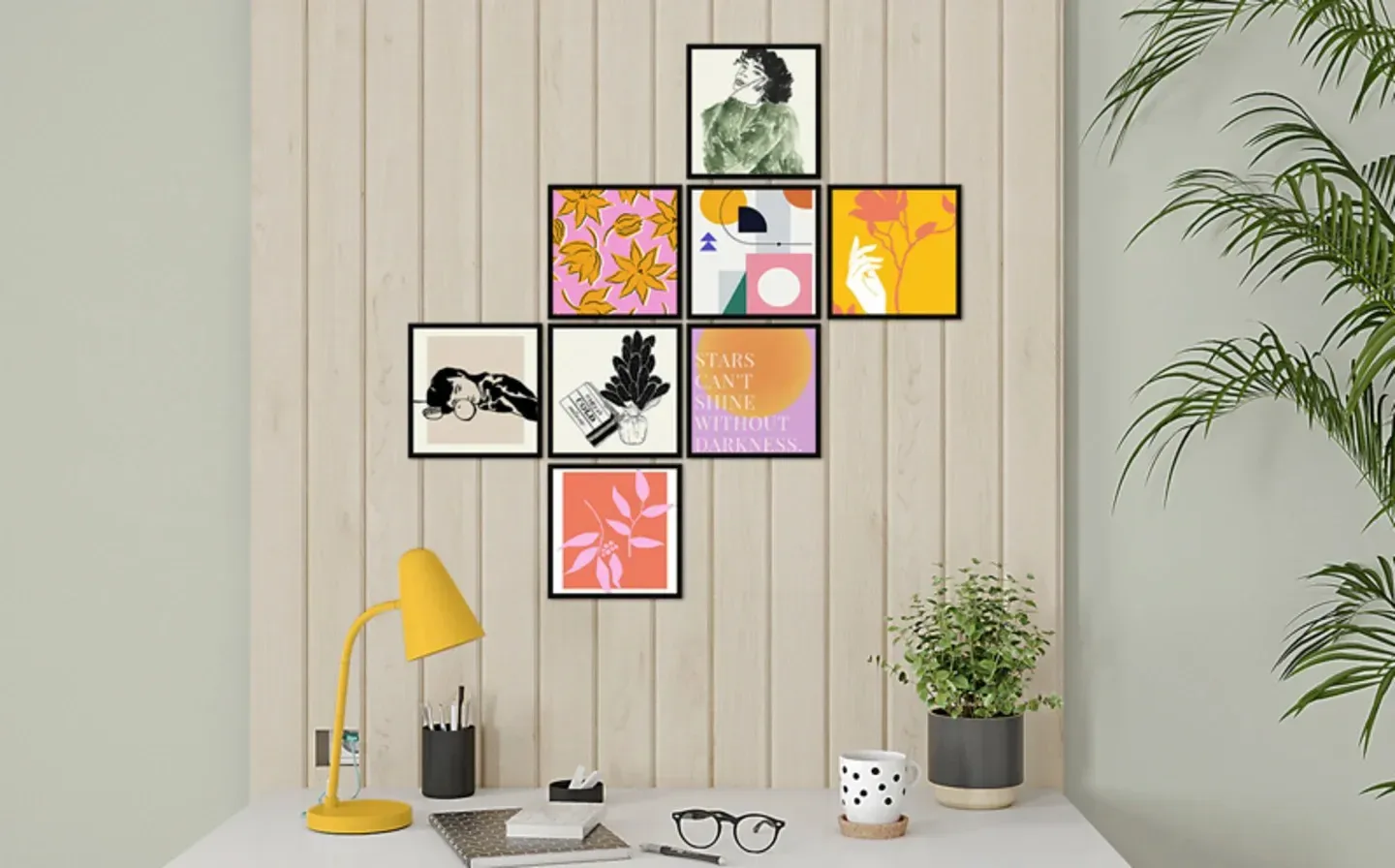 A well-arranged desk with a lamp, a plant, and a series of framed photo tiles