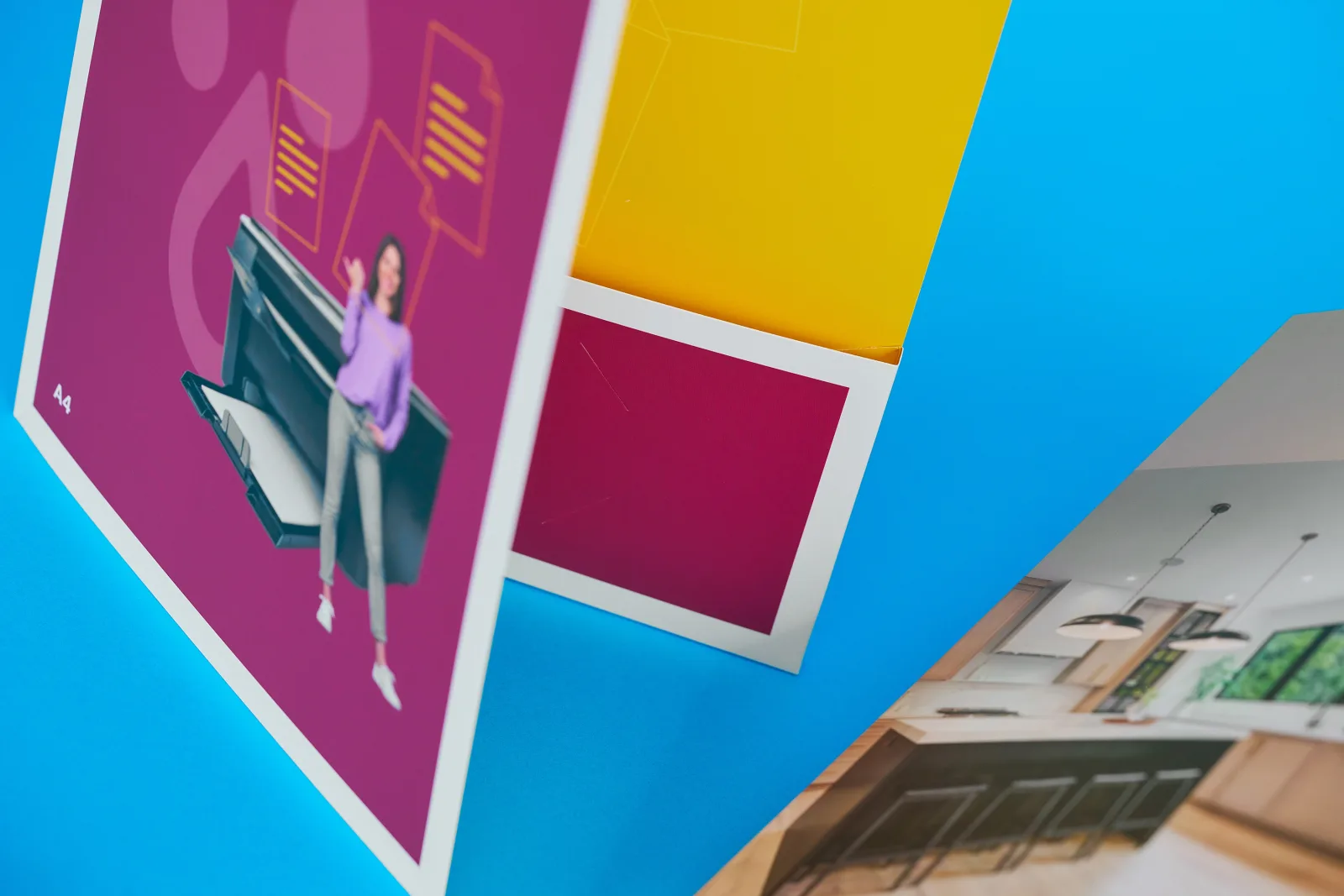 close up of a4 purple and yellow presentation folder with woman and printer image on a bright blue background