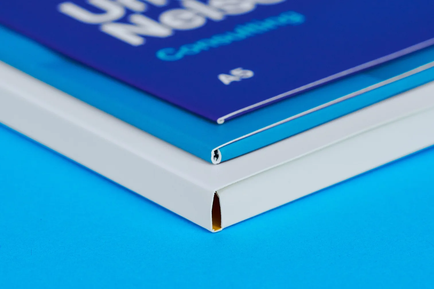 close up of sides of 3 presentation folders showing 0mm, 4mm and 10mm capacity on a bright blue background