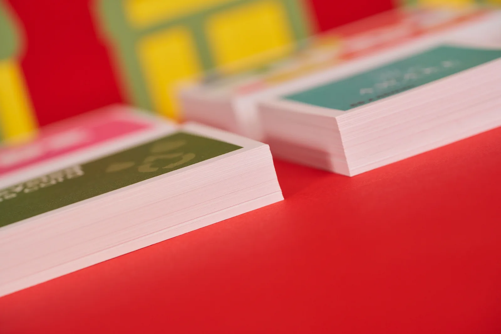 piles of recycled business cards on bright red background
