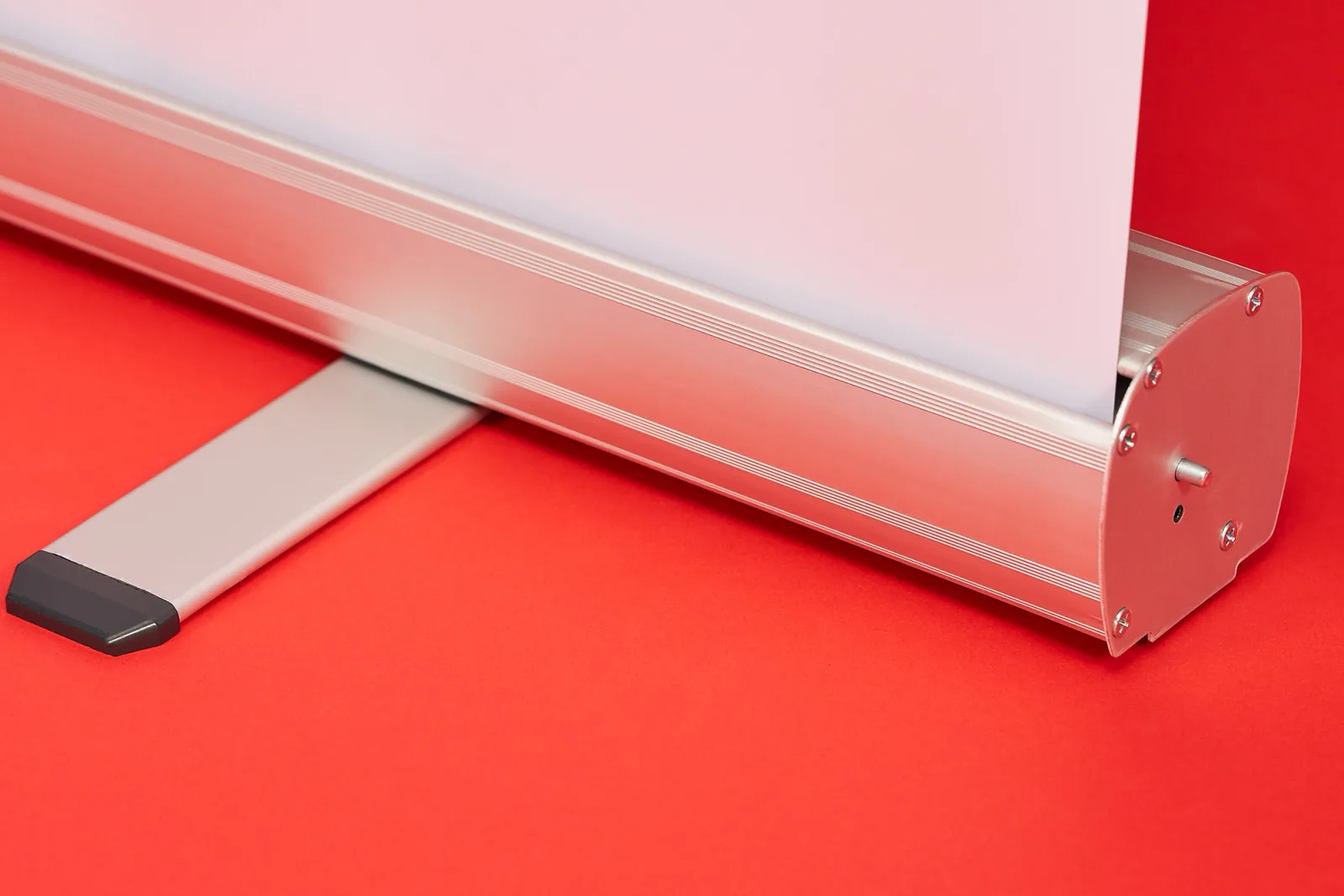 silver budget roller banner cassette base with white graphic and folded out foot on a bright red background