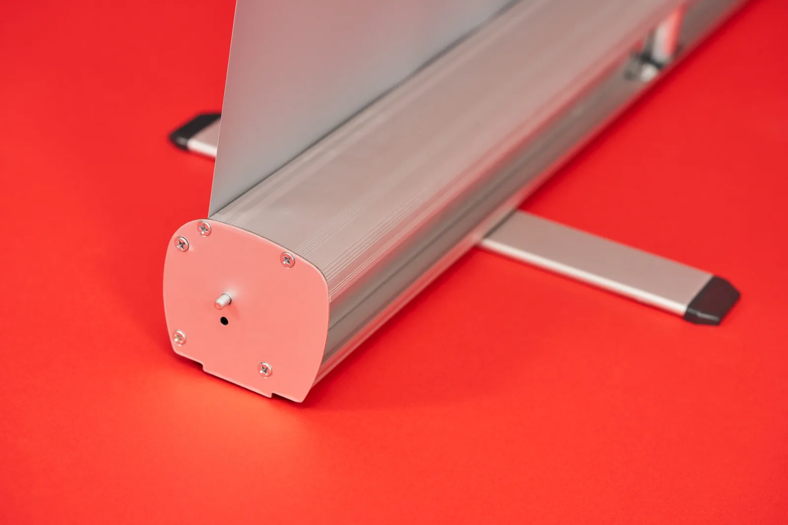 back of silver budget roller banner cassette with support foot on a bright red background
